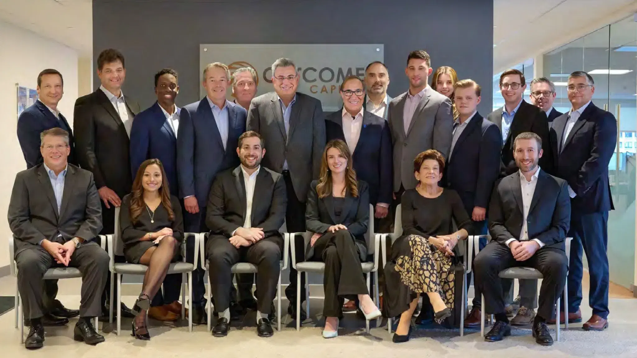 Outcome Capital team photo in the reception area of their Boston office, by Damon Bates