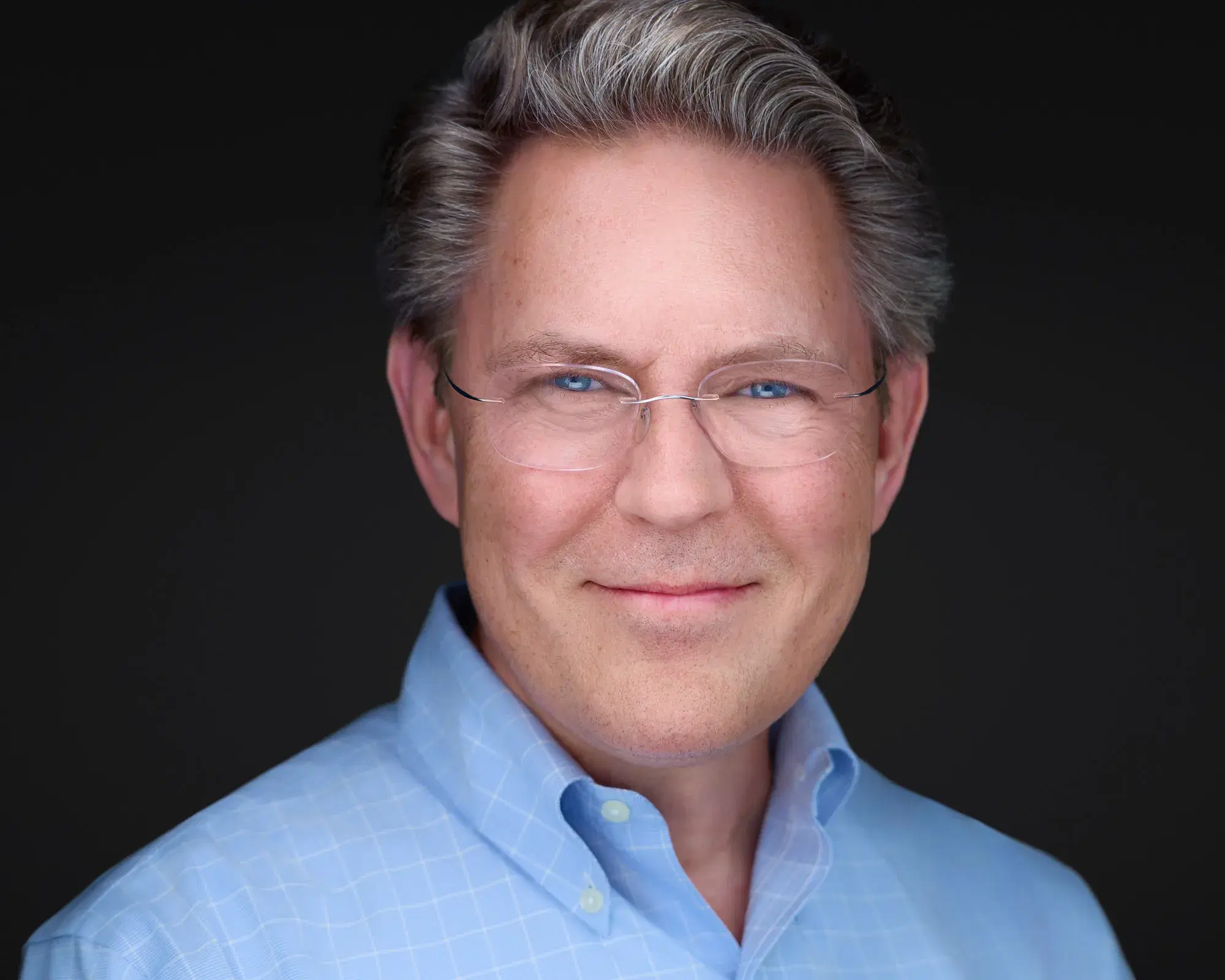 Damon Bates, headshot photographer, smiling, light blue shirt and glasses — Damon Bates Photography, Sherborn MA