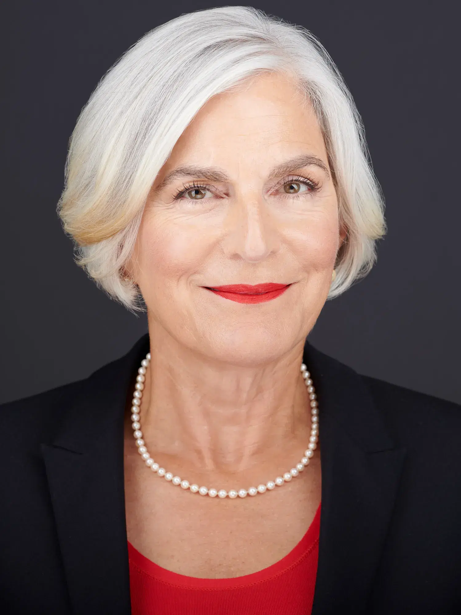 Portrait orientation headshot with shoulders cropped out — subject looks compressed and confined, posture and authority diminished