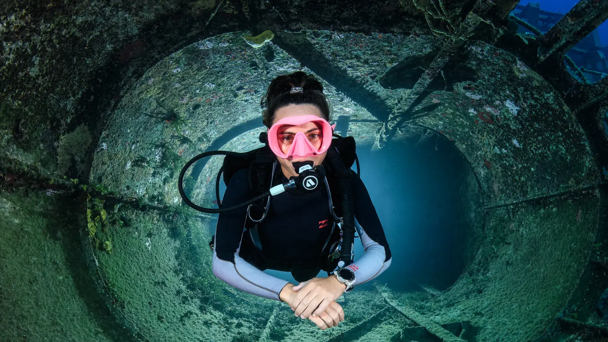 Diver in shipwreck porthole photographed by Damon Bates